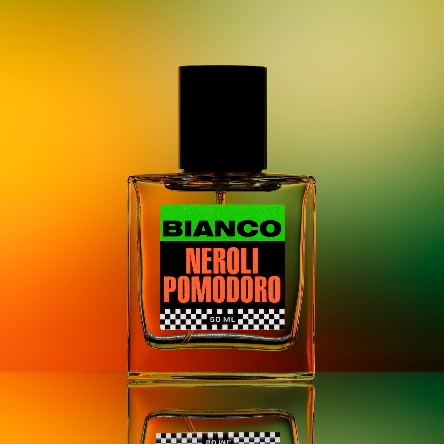 Bianco Profumo's Neroli Pomodoro featuring notes of Green Mandarin (Vert de Mandarin Orpur), Sicilian Blood Orange, Orange Blossom, Neroli, Petitgrain, Basil, Tomato Leaf, Marigold, Amber, and Musk. Bottle on a mirrored surface with an orange & green background.