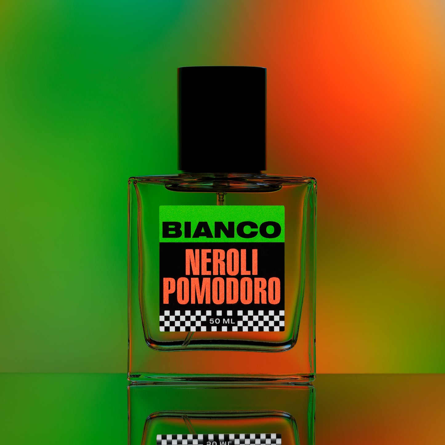 Bianco Profumo's Neroli Pomodoro featuring notes of Green Mandarin (Vert de Mandarin Orpur), Sicilian Blood Orange, Orange Blossom, Neroli, Petitgrain, Basil, Tomato Leaf, Marigold, Amber, and Musk. Bottle on a mirrored surface with a green & orange background.