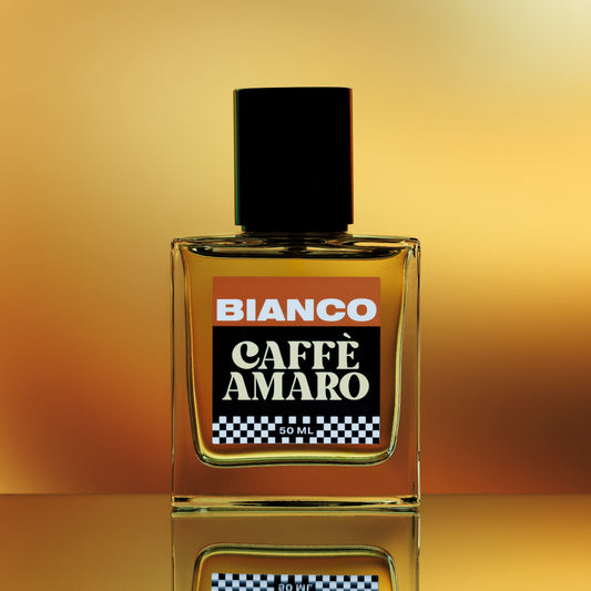 Bianco Caffè Amaro perfume bottle on a reflective surface with a gradient background